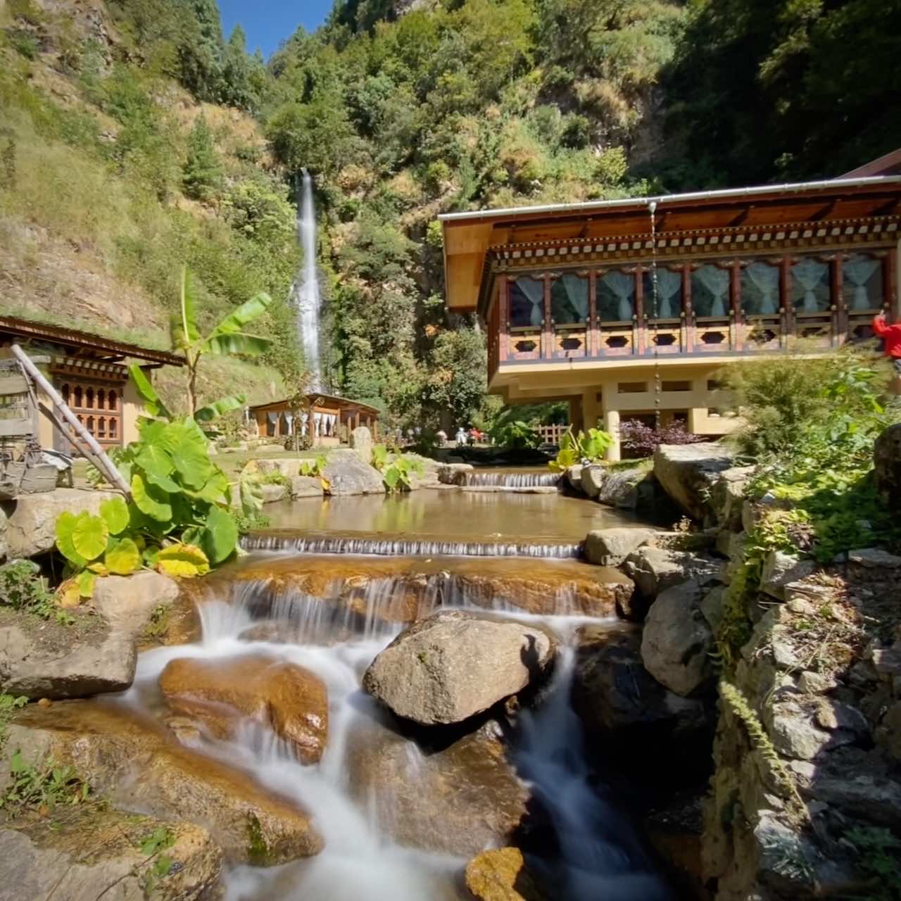 A waterfall outside a scenic restaurant in Bhutan