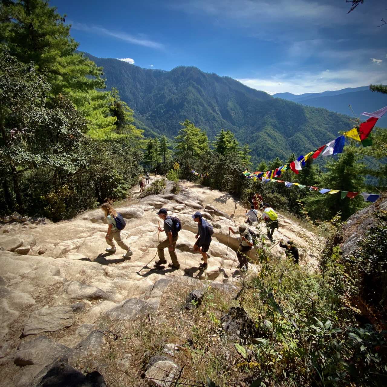 Cyclists treking to Tiger's Nest as part of a cycling holiday in Bhutan