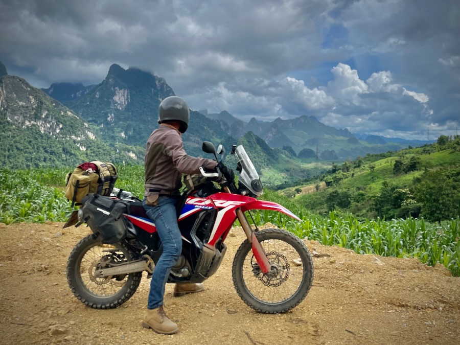 A Honda CRF300 Rally in front of a mountain scene in Laos