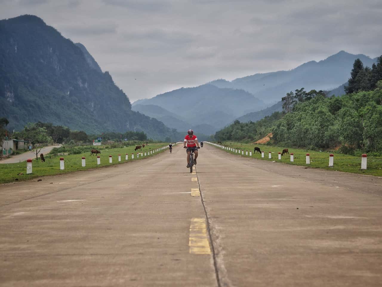 cyclist on old US runway central Vietnam