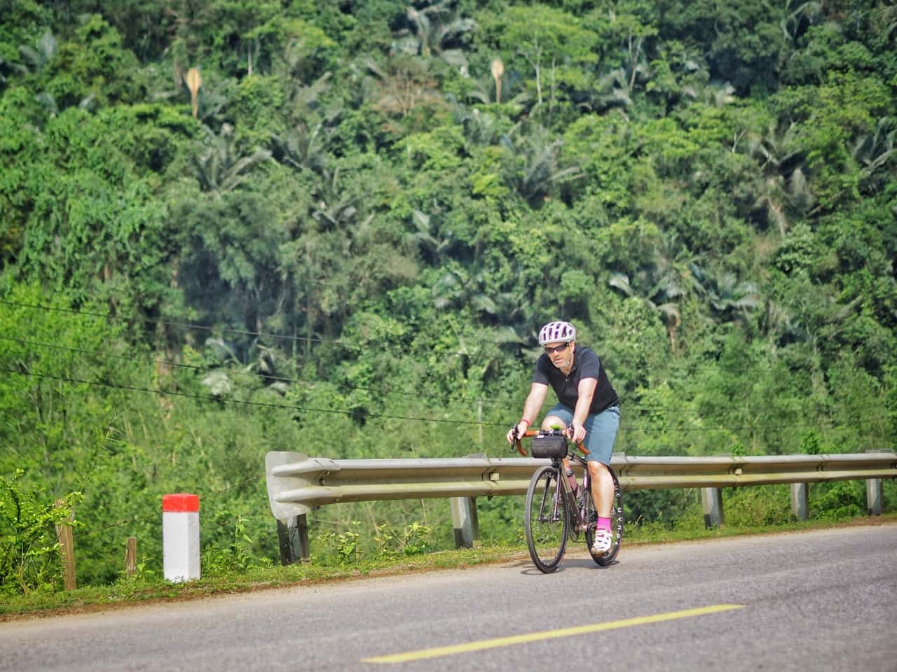 cyclist on jungle road vietnam